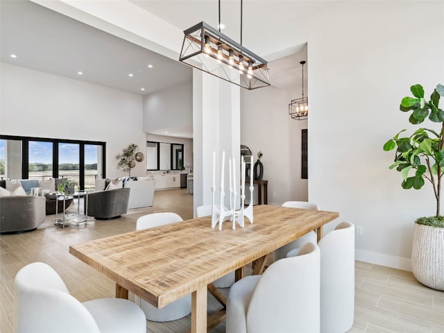 dining space featuring a towering ceiling