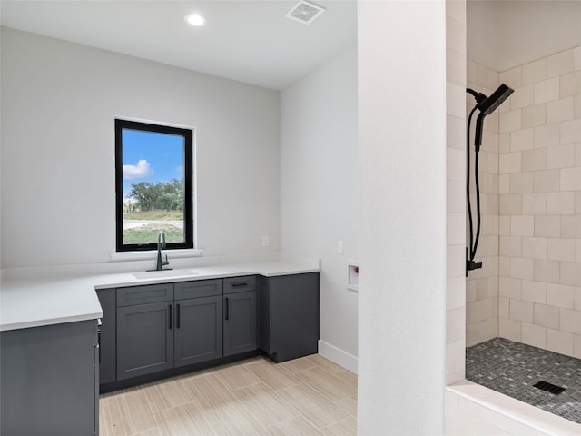 bathroom featuring vanity and tiled shower