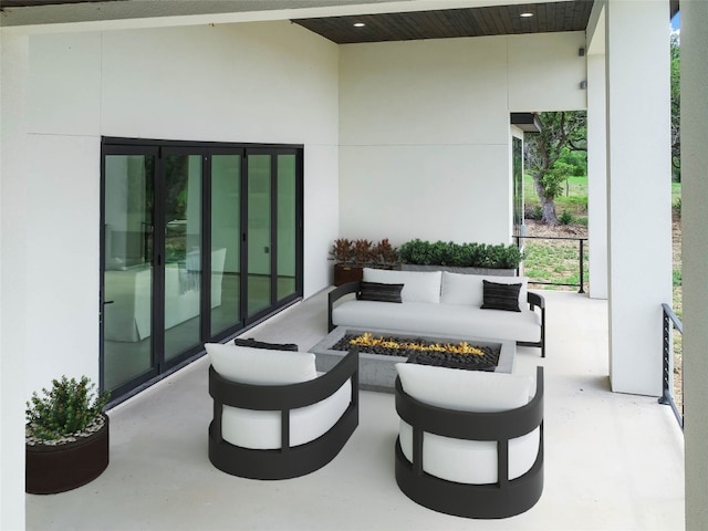 view of patio / terrace featuring an outdoor living space with a fire pit