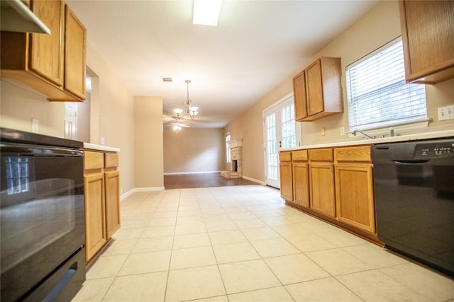 kitchen featuring a notable chandelier, range, black dishwasher, hanging light fixtures, and light tile patterned flooring