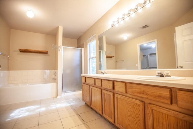 bathroom with tile patterned flooring, vanity, and plus walk in shower