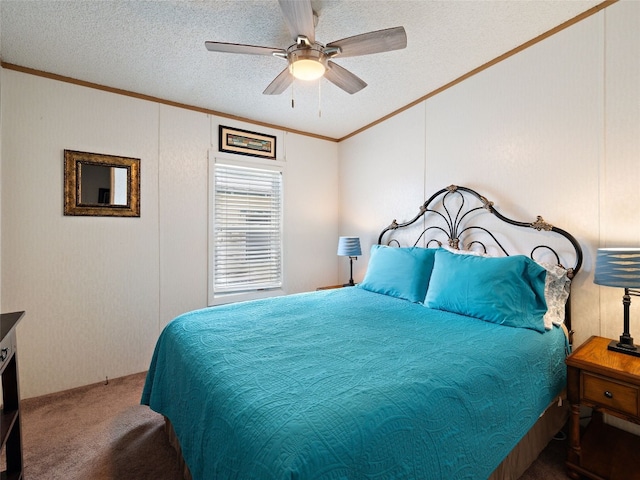 carpeted bedroom with a textured ceiling, ceiling fan, and crown molding