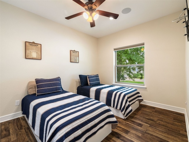 bedroom with dark hardwood / wood-style floors and ceiling fan