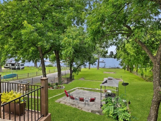 exterior space with a yard, a water view, and a patio area