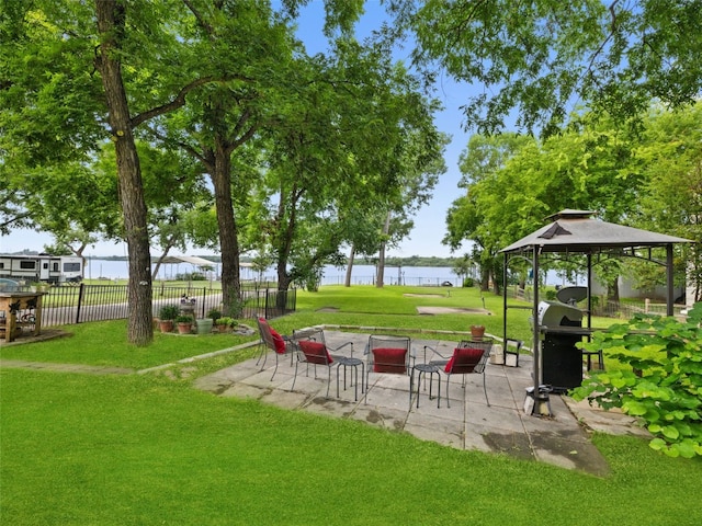 view of yard with a water view, a patio, and a gazebo