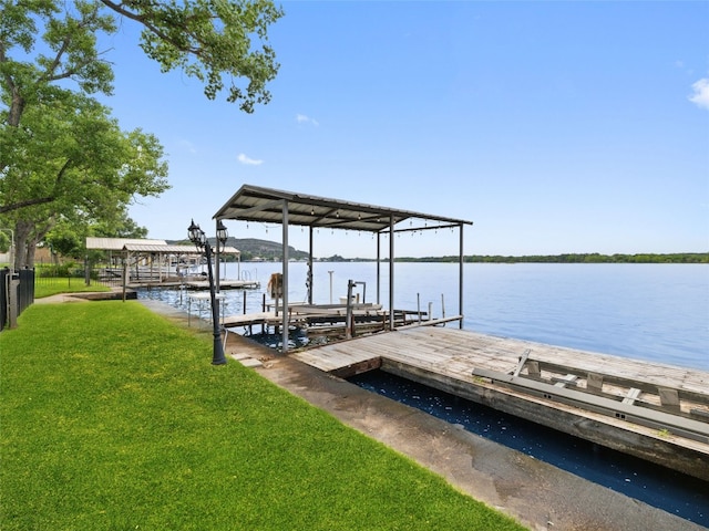 view of dock featuring a water view and a lawn