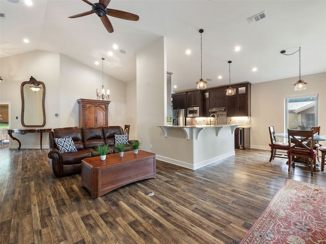 living room with sink, high vaulted ceiling, ceiling fan with notable chandelier, and dark hardwood / wood-style flooring