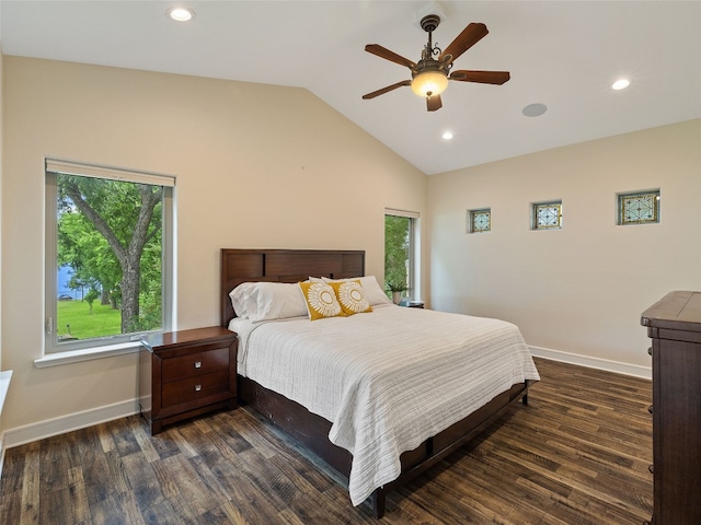 bedroom featuring dark wood-type flooring, vaulted ceiling, and ceiling fan