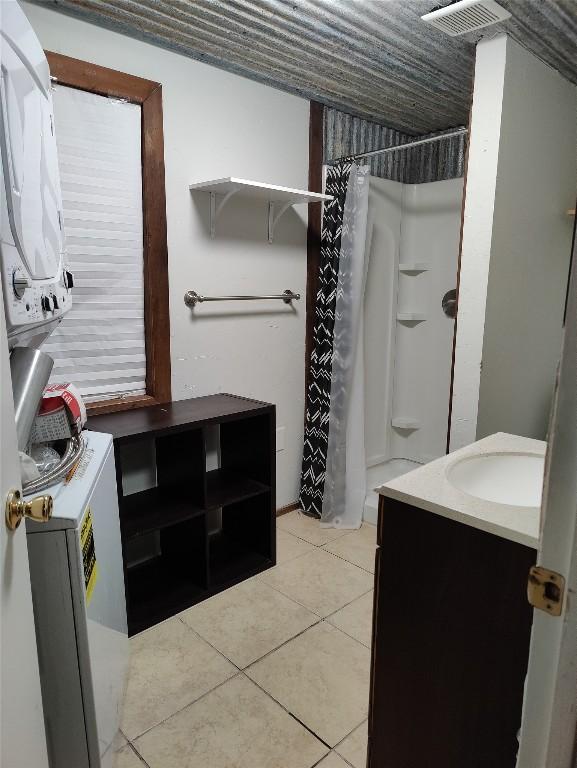 bathroom featuring tile patterned flooring and vanity