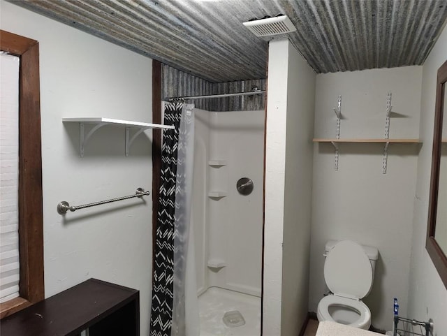 bathroom featuring toilet and walk in shower