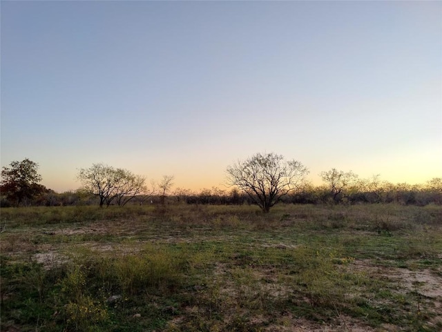 nature at dusk featuring a rural view