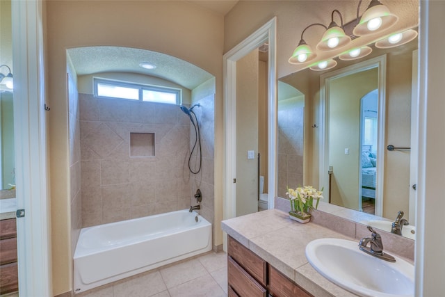 bathroom featuring tile patterned floors, tub / shower combination, and vanity