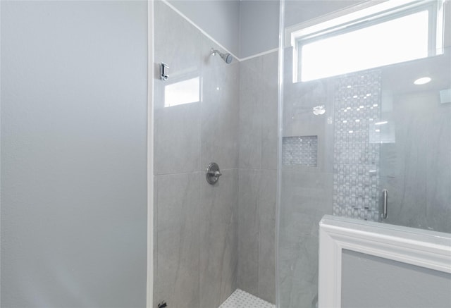 bathroom with an enclosed shower and a healthy amount of sunlight