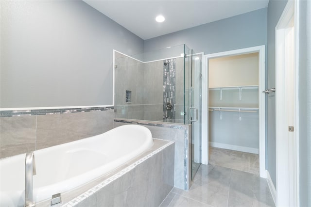 bathroom with separate shower and tub and tile patterned flooring