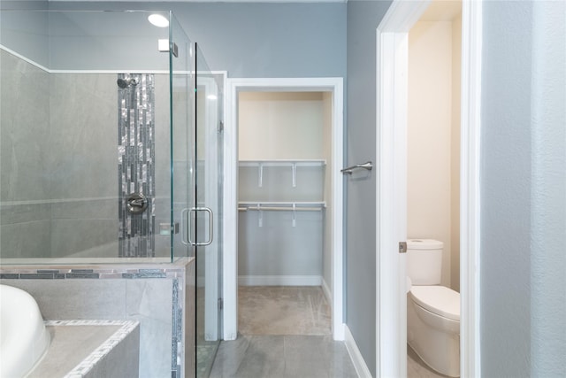 bathroom with tile patterned floors, plus walk in shower, and toilet