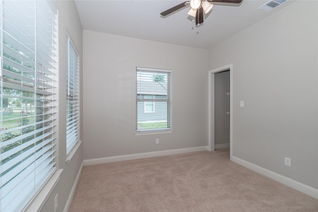 carpeted empty room featuring ceiling fan