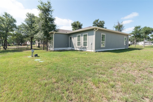 view of side of home with a lawn