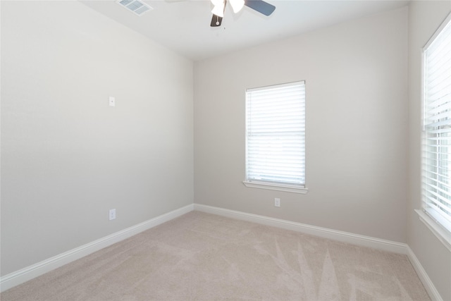 carpeted spare room with ceiling fan