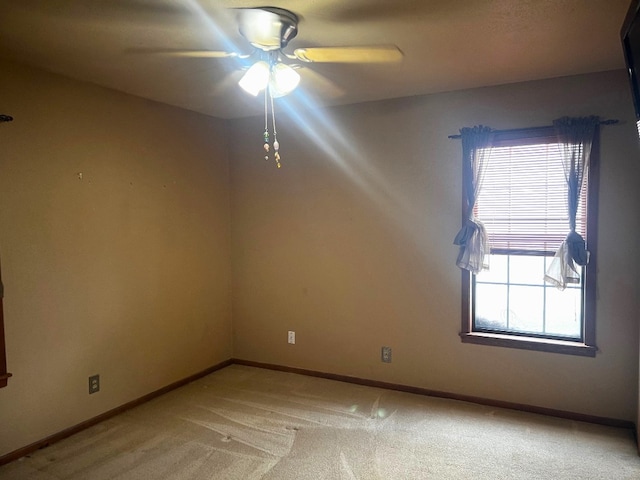 empty room featuring carpet floors and ceiling fan