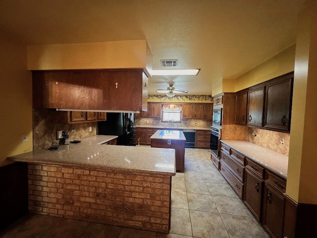 kitchen with kitchen peninsula, ceiling fan, black appliances, decorative backsplash, and sink