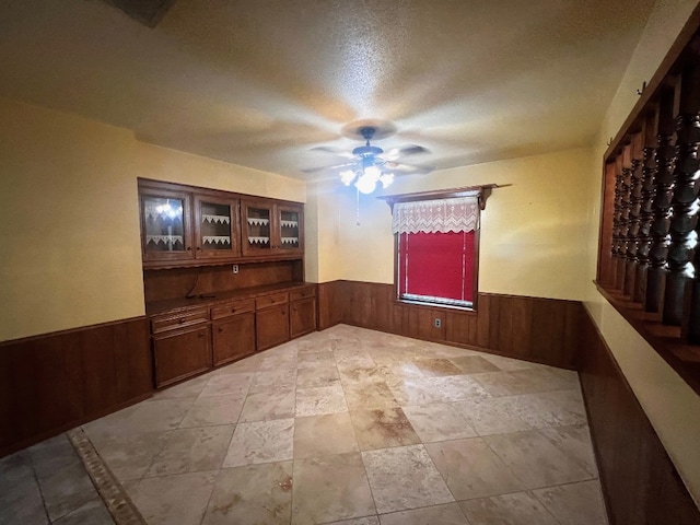 tiled empty room with ceiling fan