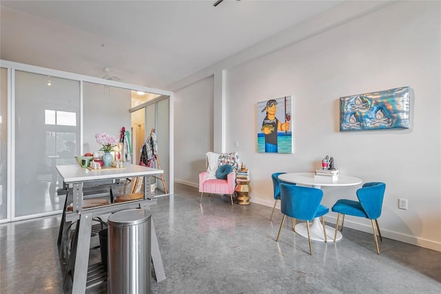 2124 E 6th St Unit 305, Austin, TX 78702 - dining space featuring baseboards and finished concrete floors