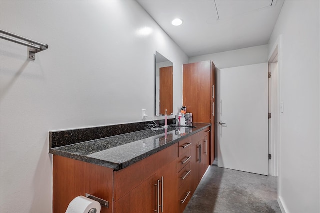 bathroom with vanity and concrete floors