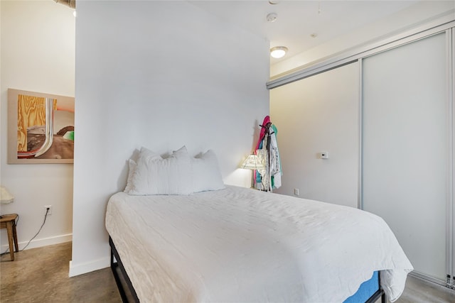 bedroom featuring a closet and concrete floors