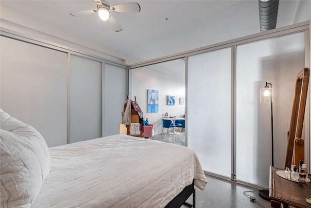 bedroom featuring a closet, concrete floors, and ceiling fan