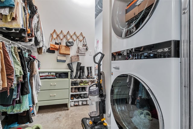 laundry area featuring stacked washer / drying machine