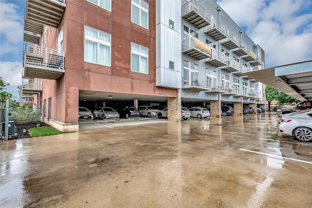 view of property featuring central AC and a carport