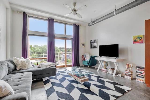 2124 E 6th St Unit 305, Austin, TX 78702 - living room with finished concrete flooring, a ceiling fan, and a towering ceiling