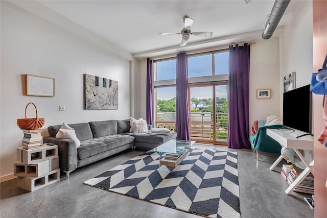 living room with concrete flooring and ceiling fan