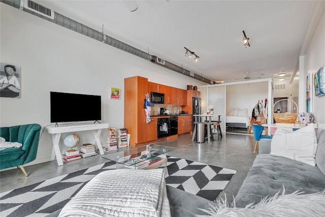 2124 E 6th St Unit 305, Austin, TX 78702 - living area with concrete flooring, ceiling fan, and rail lighting