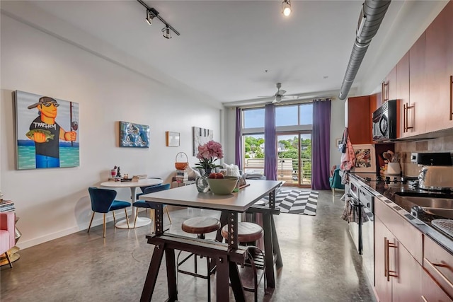2124 E 6th St Unit 305, Austin, TX 78702 - dining room with concrete flooring, track lighting, a ceiling fan, and baseboards