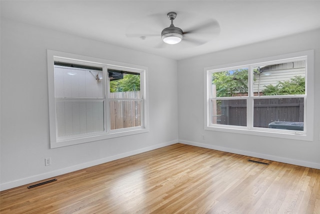 empty room featuring light hardwood / wood-style floors, plenty of natural light, and ceiling fan