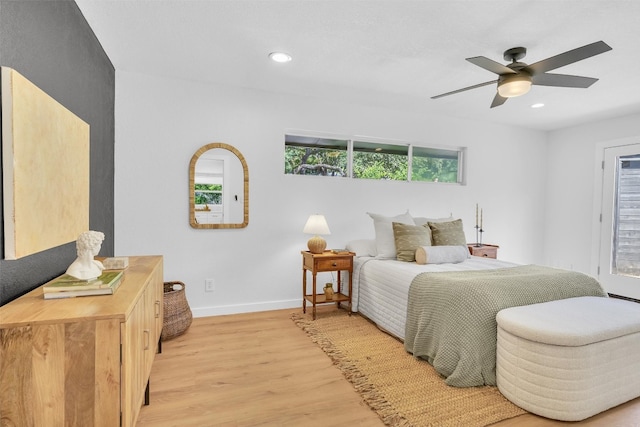 bedroom with ceiling fan and light hardwood / wood-style floors