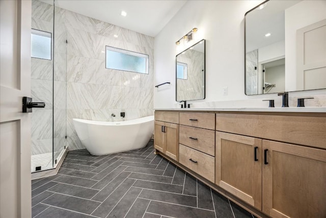 bathroom with tile patterned flooring, plus walk in shower, a wealth of natural light, and vanity