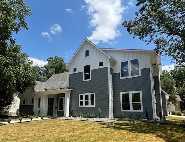 3001 Funston St, Austin, TX 78703 - rear view of house with board and batten siding and a lawn