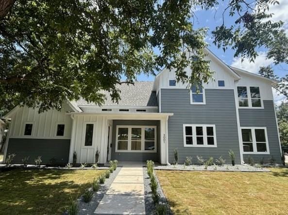 3001 Funston St, Austin, TX 78703 - back of house with board and batten siding and a yard