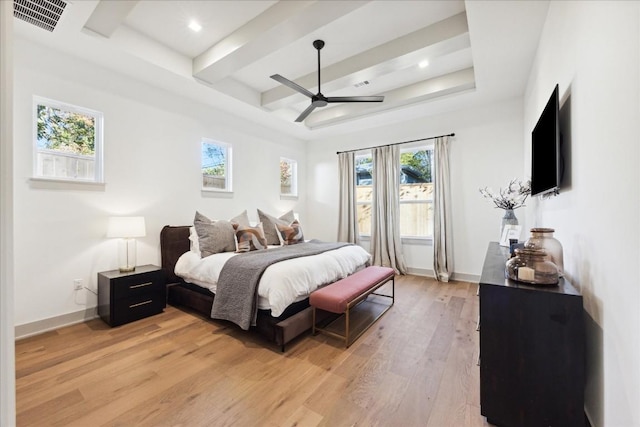 bedroom featuring ceiling fan, a tray ceiling, beamed ceiling, and light wood-type flooring