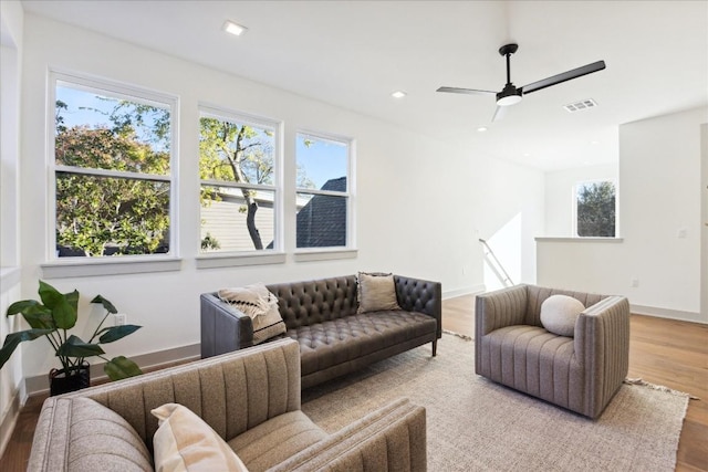 living room with hardwood / wood-style floors and ceiling fan