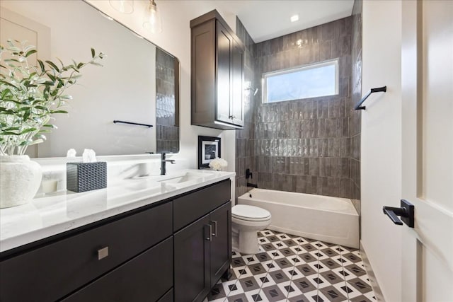 full bathroom with tiled shower / bath combo, vanity, and toilet