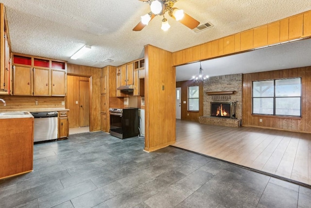 kitchen with plenty of natural light, dark hardwood / wood-style floors, stainless steel appliances, and hanging light fixtures