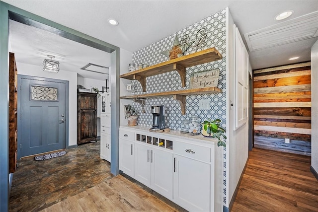 bar featuring white cabinets, dark wood-type flooring, and tasteful backsplash