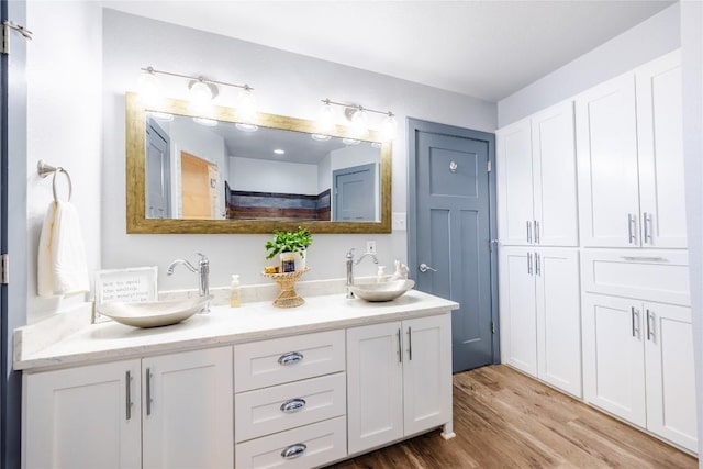 bathroom featuring vanity and hardwood / wood-style flooring