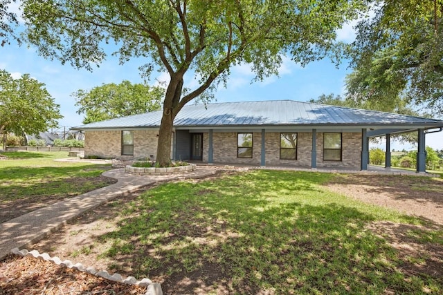 8712 Cele Rd Unit 1, Manor, TX 78653 - ranch-style home featuring a front yard, metal roof, and brick siding