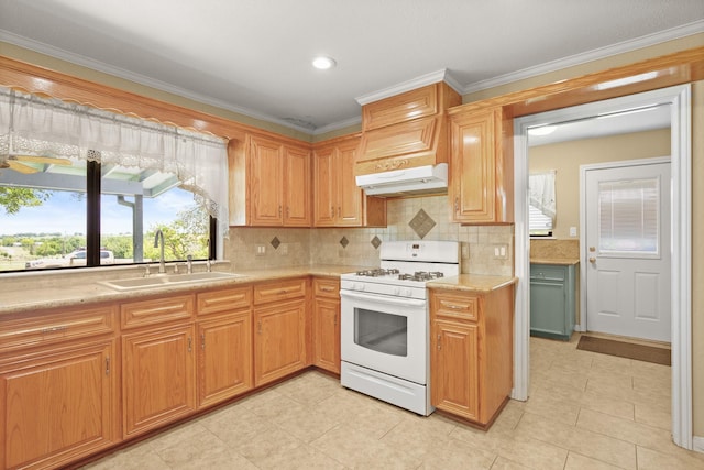 kitchen with light tile patterned flooring, sink, decorative backsplash, ornamental molding, and white range with gas cooktop