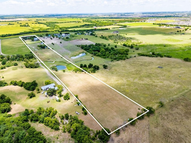 birds eye view of property with a rural view