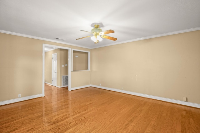 spare room with crown molding, ceiling fan, and light hardwood / wood-style flooring